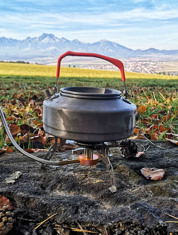 What safety precautions should be taken when using a camping pot outdoors?